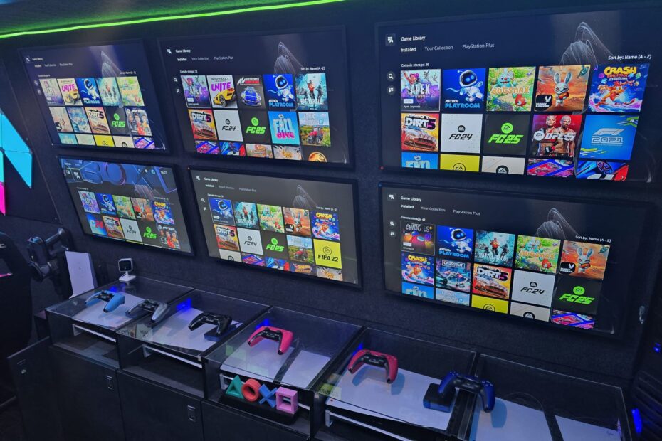 Wide interior shot of the Mobile Gaming Van showing racing seats, steering wheel, and screens