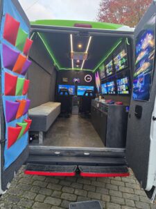 Racing simulator setup inside a mobile gaming van with Xbox Series X in London and Hertfordshire